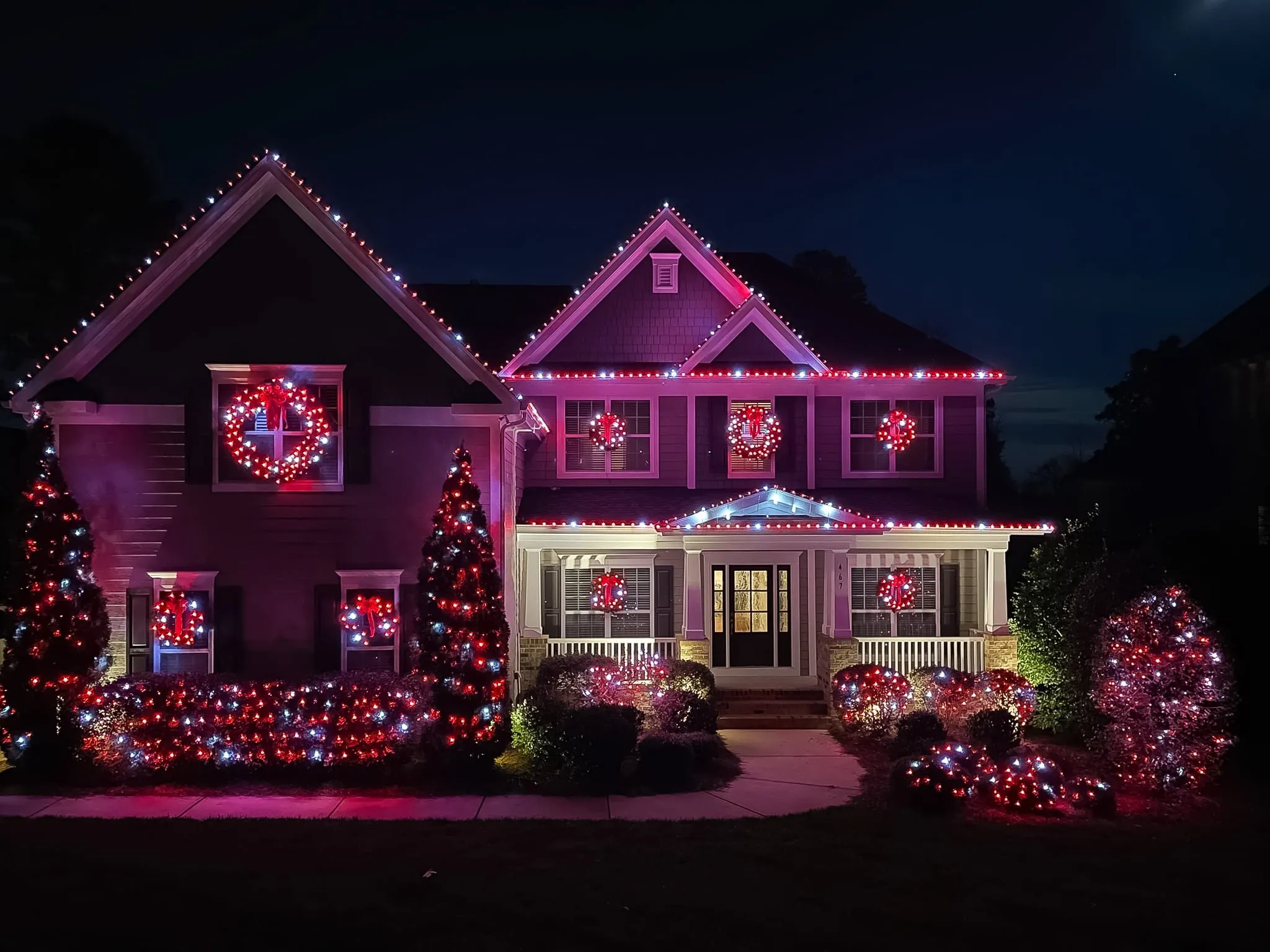 Festively lit house with Christmas decorations by Power Blast Lighting in Louisville, Kentucky, transforming it into a winter wonderland.